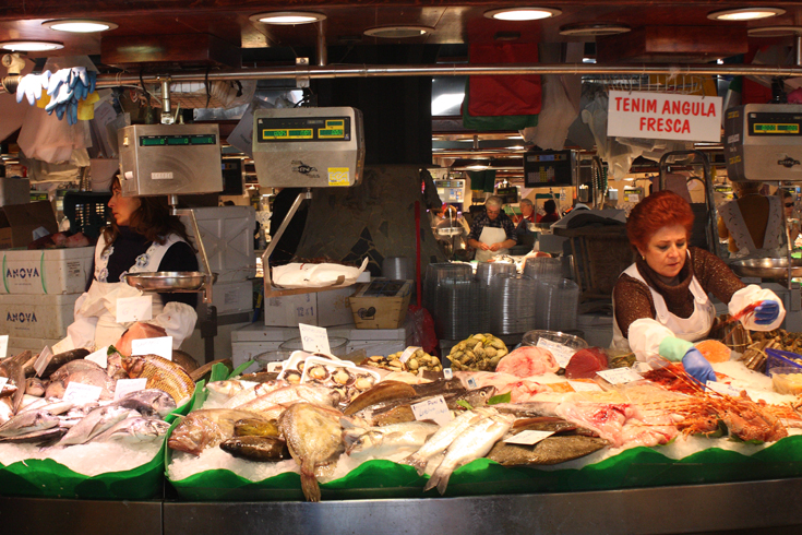 Flavors, scenes and scents of Catalan fill this historic covered market - it's where locals have gathered to taste, chat, gossip and shop for nearly a century. Join them to check out the piles of crimson forest fruits, plump green olives stuffed with garlic, and spicy charcuterie. It's a great place to stock up for a picnic! (Photo Credits: © Sergi Camara)